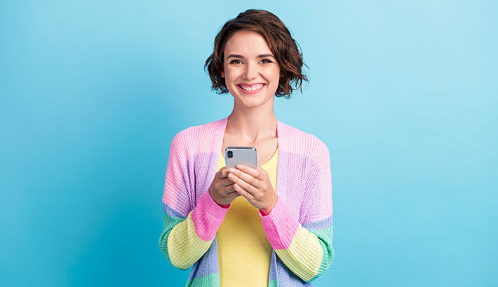 Happy woman with phone spring